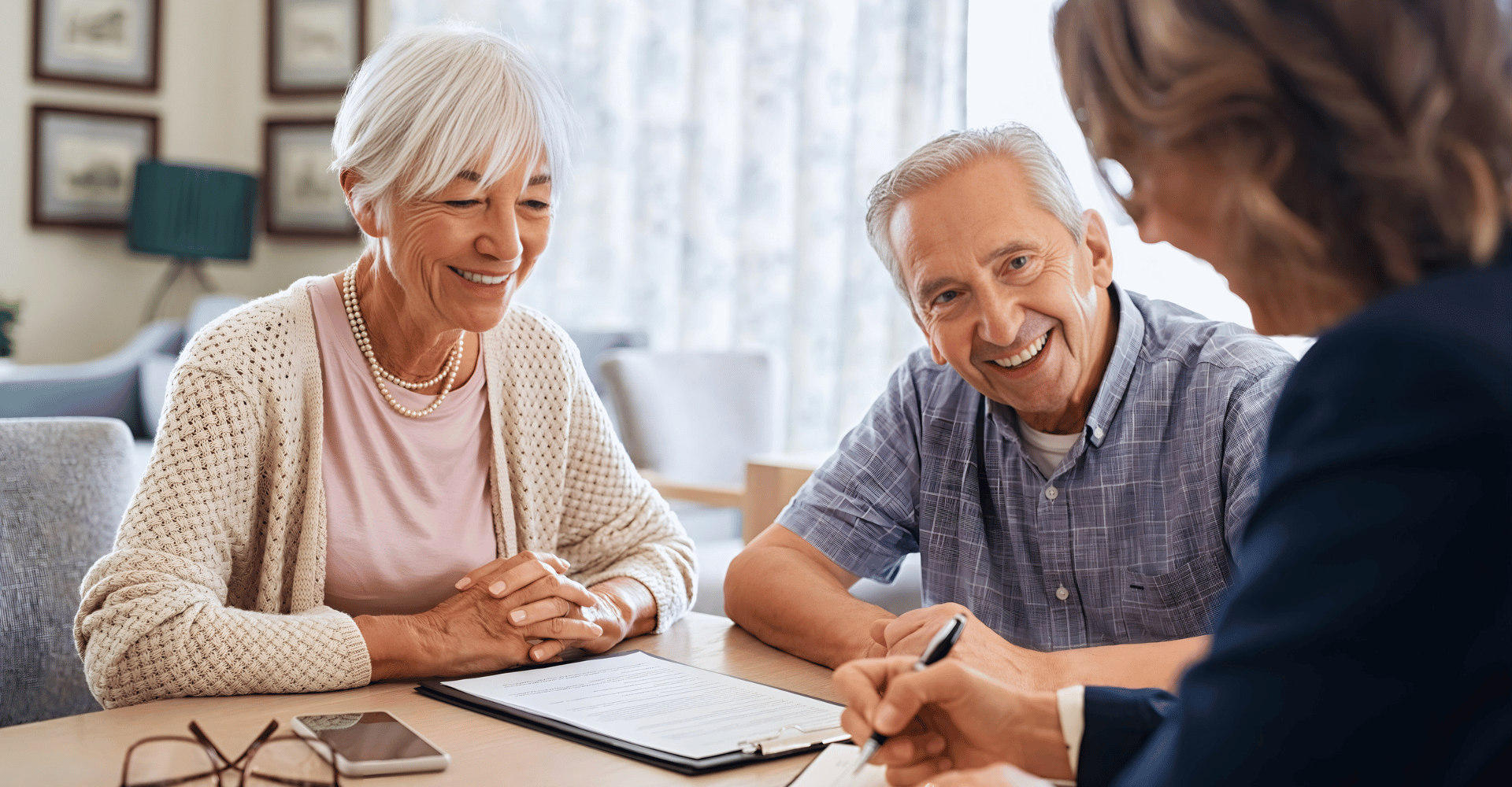 Couple reviewing retirement and financial planning strategies with advisor for long term financial security